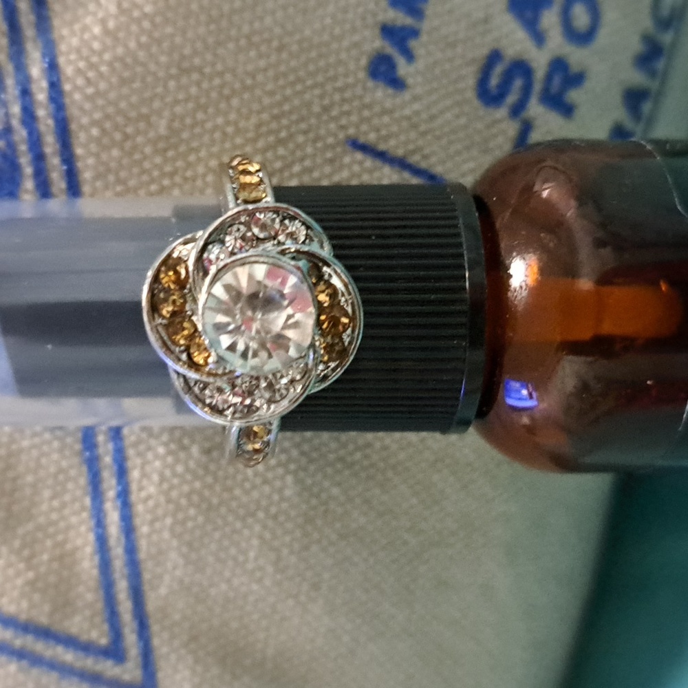 A beautiful,silver flower ring with brown stones.